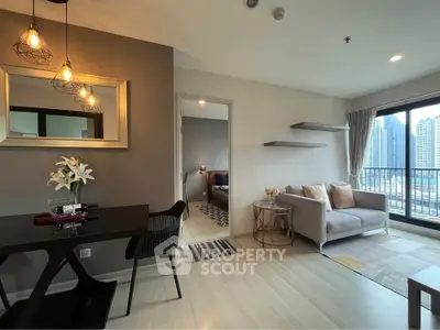 Modern living room with stylish decor and city view balcony in a high-rise apartment.