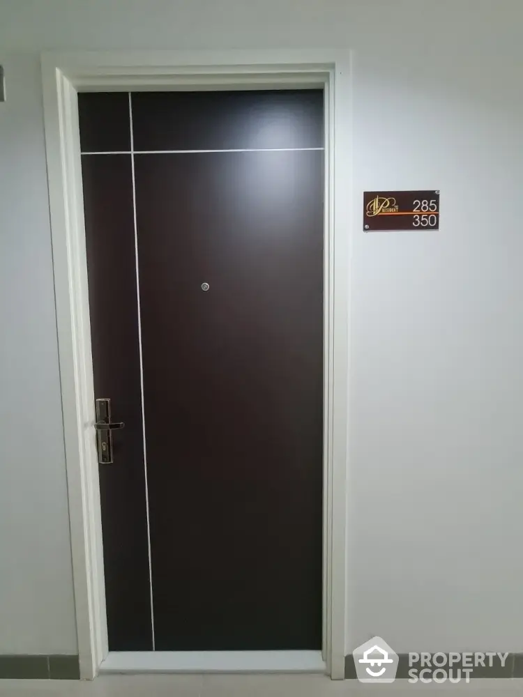 Modern apartment entrance door with sleek design and room number plaque