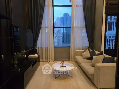 Luxurious living room with stunning city view, elegant decor, and cozy seating area.