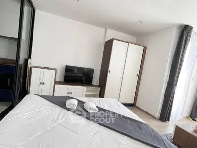 Modern bedroom with TV and wardrobe, bright natural light