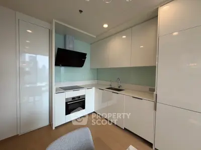 Modern kitchen with sleek white cabinets and built-in appliances