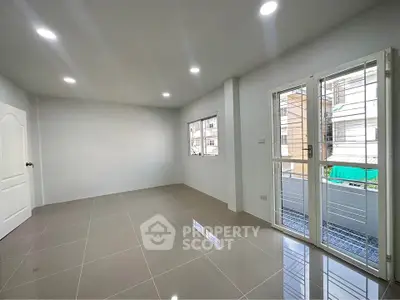 Spacious unfurnished room with large windows and tiled flooring, perfect for customization.