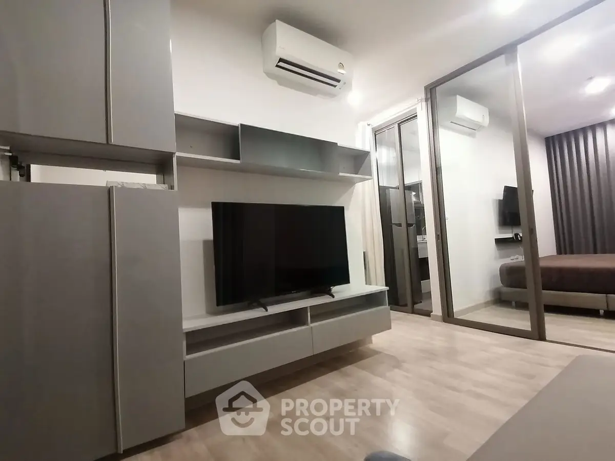 Modern living room with sleek furniture and air conditioning in a stylish apartment.