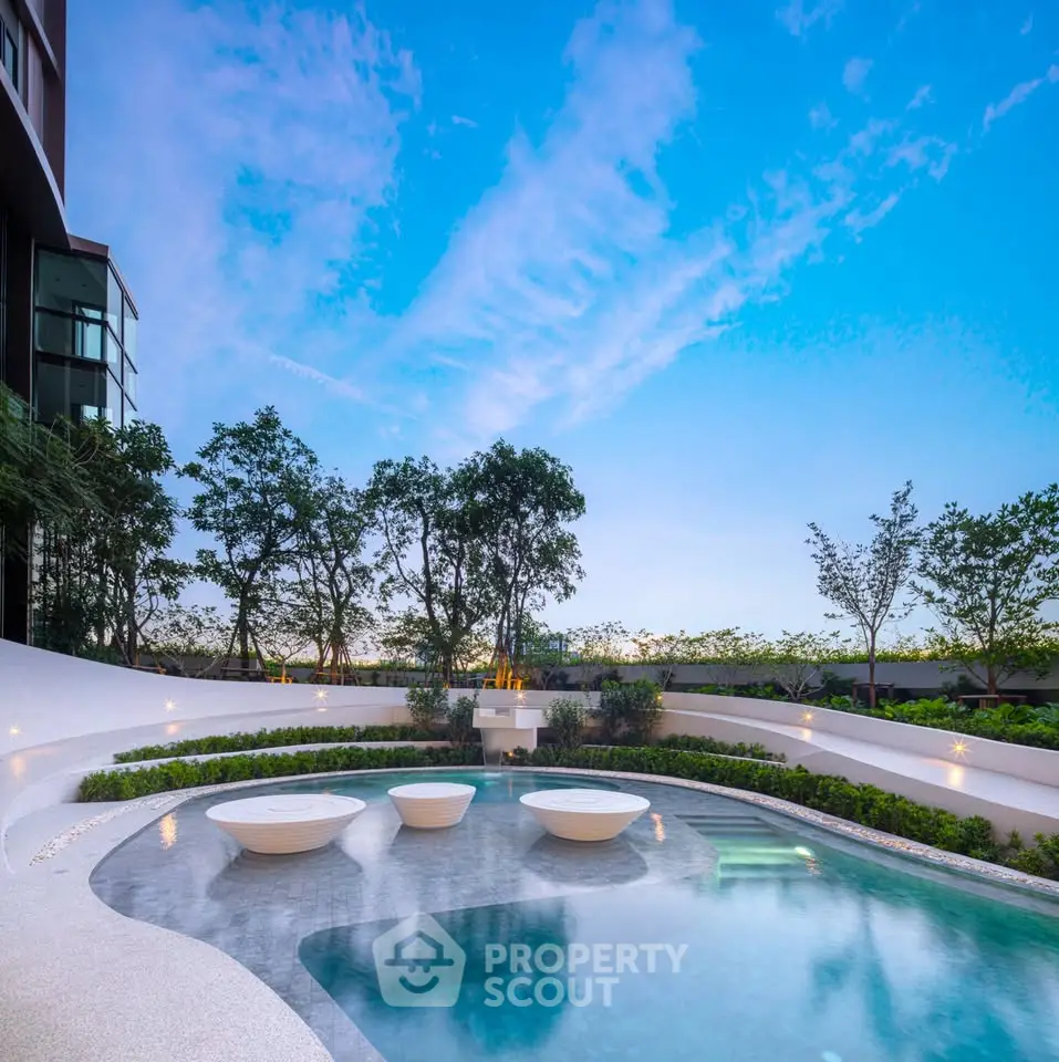 Luxurious outdoor pool area with modern design and lush greenery, perfect for relaxation and leisure.
