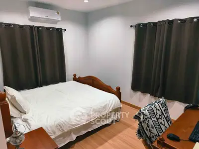 Cozy bedroom with wooden furniture and air conditioning, perfect for restful nights.