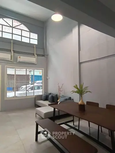 Spacious modern living room with high ceilings and stylish furniture