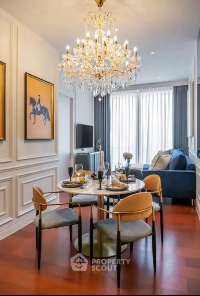 Luxurious dining area with elegant chandelier and stylish decor in modern apartment.