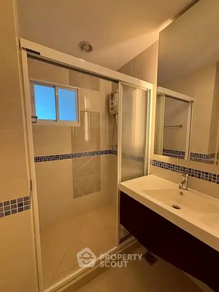 Modern bathroom with glass shower enclosure and sleek vanity