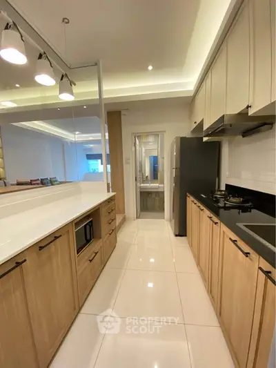 Modern kitchen with sleek cabinetry and open layout in a stylish apartment.