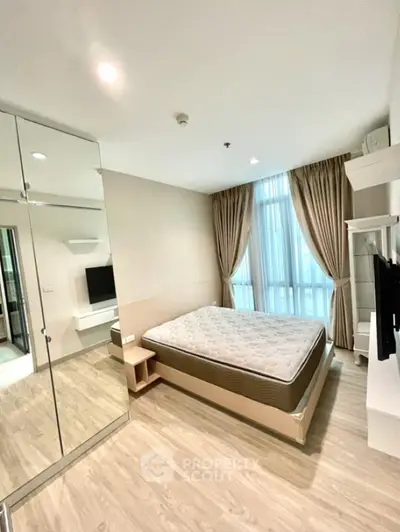 Modern bedroom with large mirror wardrobe and natural light
