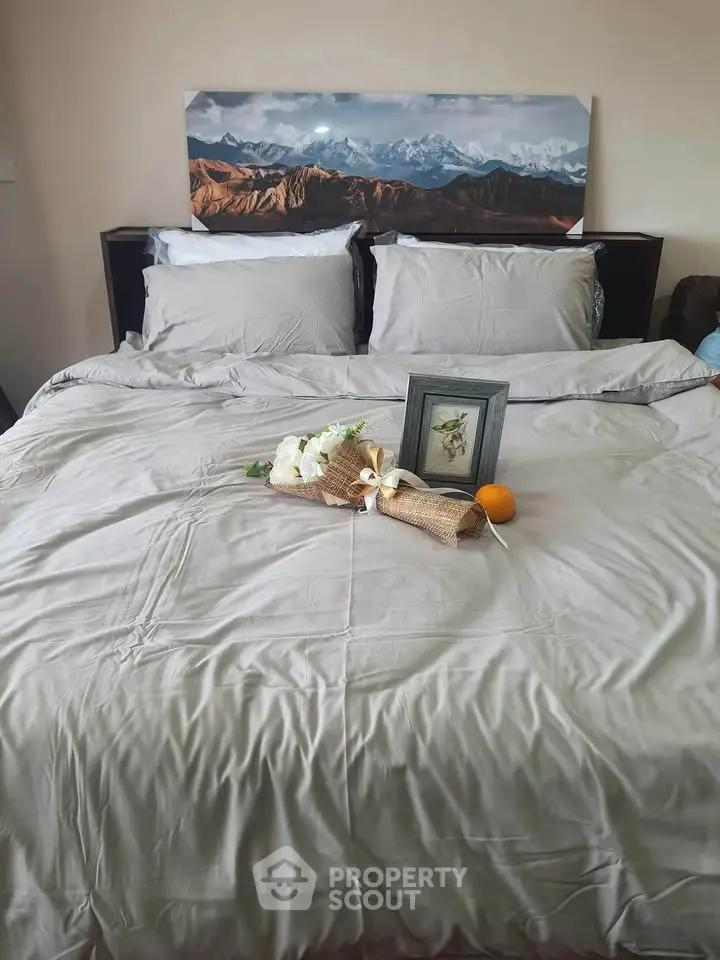 Cozy bedroom with elegant decor and mountain landscape artwork