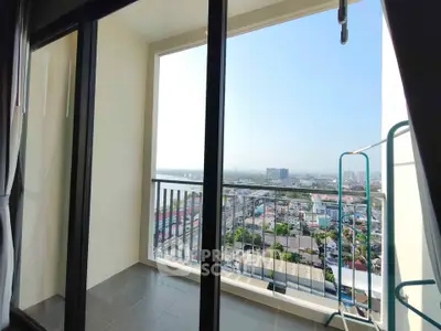 Spacious balcony with stunning city view in modern high-rise apartment.