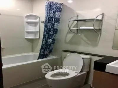 Modern bathroom with bathtub and sleek fixtures in a contemporary apartment.