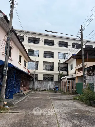 Explore this spacious multi-story building with ample parking and secure gated entrance, perfect for commercial or residential use.