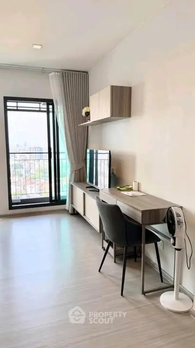 Modern living room with balcony view and stylish furniture in a high-rise apartment.