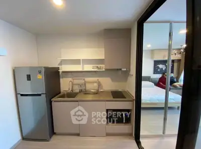 Modern compact kitchen with sleek appliances and open layout in stylish apartment