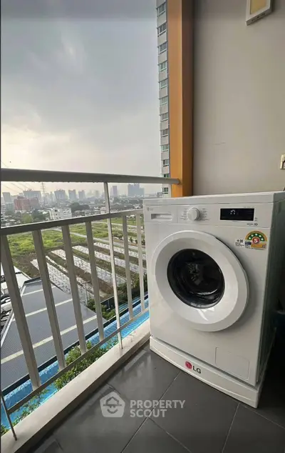Modern balcony with washing machine and city view, perfect for urban living convenience.