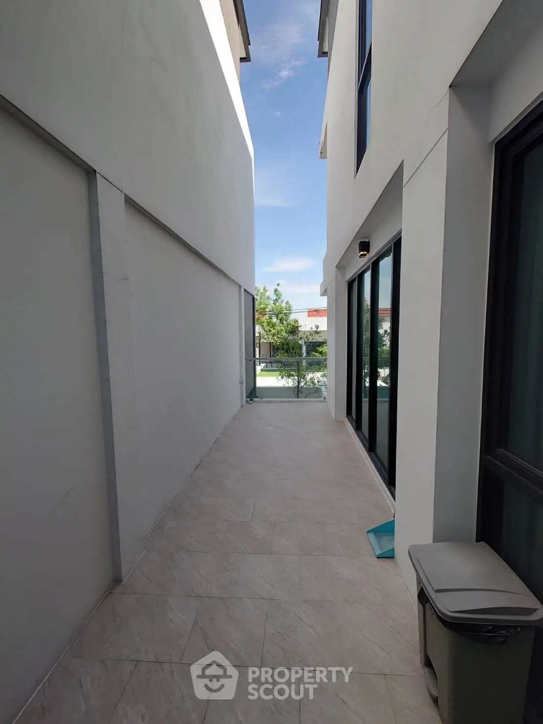 Modern narrow exterior walkway with clean lines and bright natural light