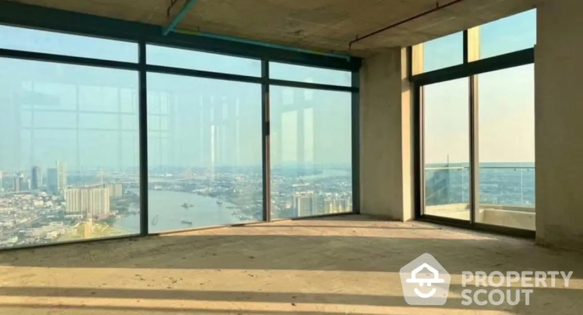 Spacious unfinished high-rise apartment with panoramic city and river views.