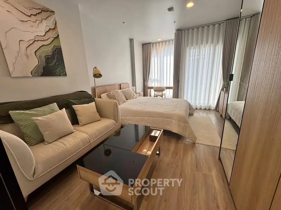 Modern bedroom with cozy seating area and stylish decor