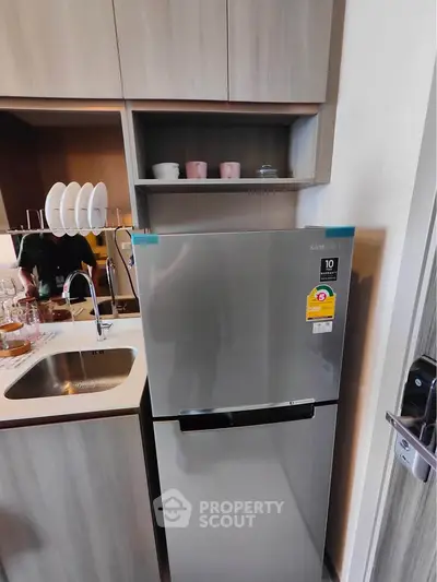 Modern kitchen with sleek fridge and stylish cabinetry
