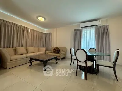 Spacious living room with elegant furniture and natural light, perfect for relaxation and entertaining.