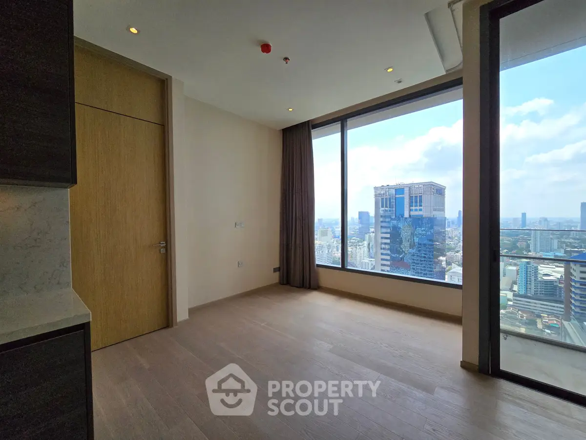 Spacious modern apartment with stunning city view and floor-to-ceiling windows.