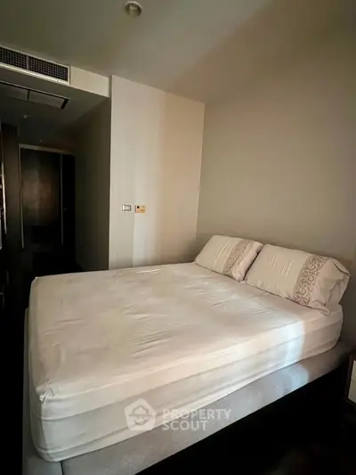 Spacious bedroom with modern design and comfortable bed in a stylish apartment.