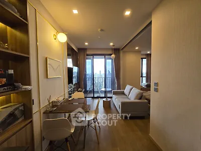 Modern living room with city view, stylish furniture, and open layout in a high-rise apartment.