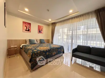 Spacious bedroom with modern decor and large window offering natural light in a stylish apartment.