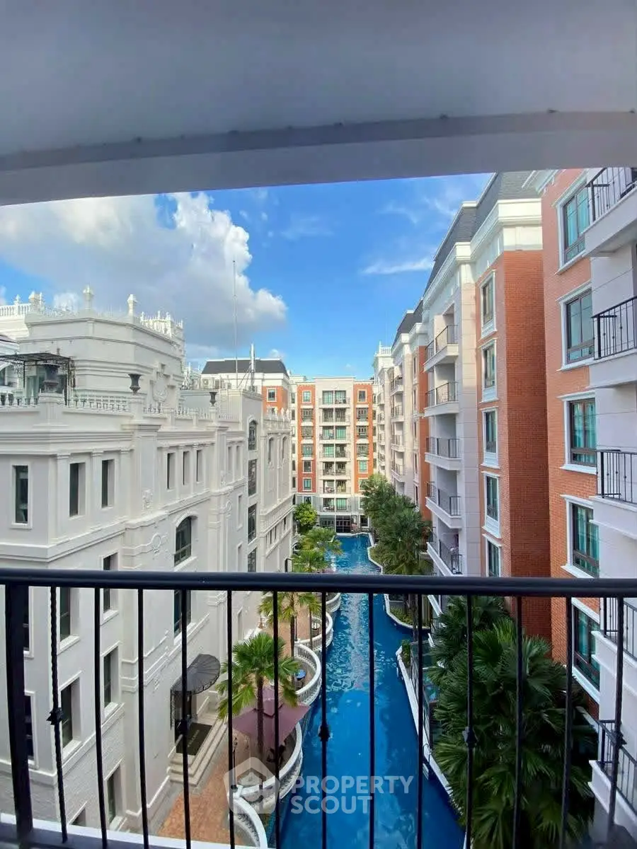 Luxurious apartment complex with stunning pool view and elegant architecture.