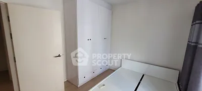 Minimalist bedroom with white wardrobe and bed frame, perfect for modern living.