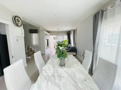 Spacious modern living room with elegant dining area and natural light