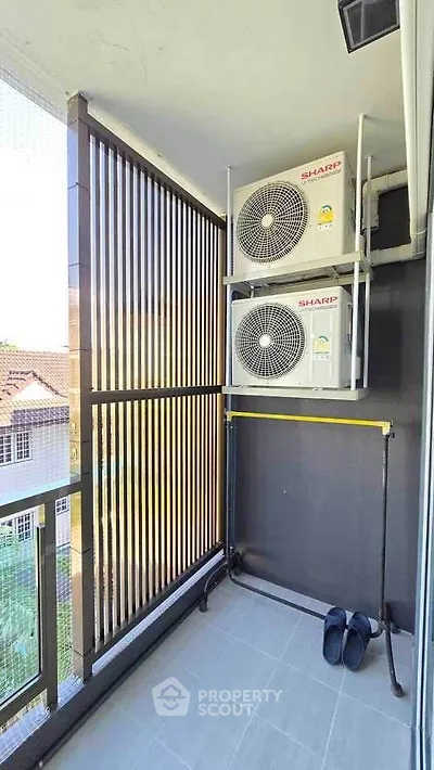 Modern balcony with air conditioning units and sleek railing design