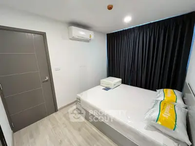 Modern bedroom with air conditioning and stylish decor in a contemporary apartment.