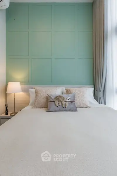 Cozy bedroom with stylish green accent wall and plush bedding