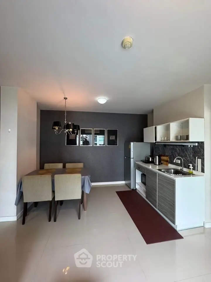 Modern open-layout kitchen and dining area with stylish decor and sleek appliances.