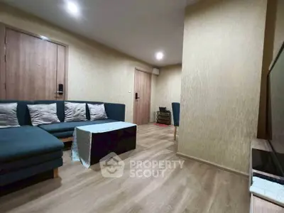 Modern living room with cozy sectional sofa and wooden flooring