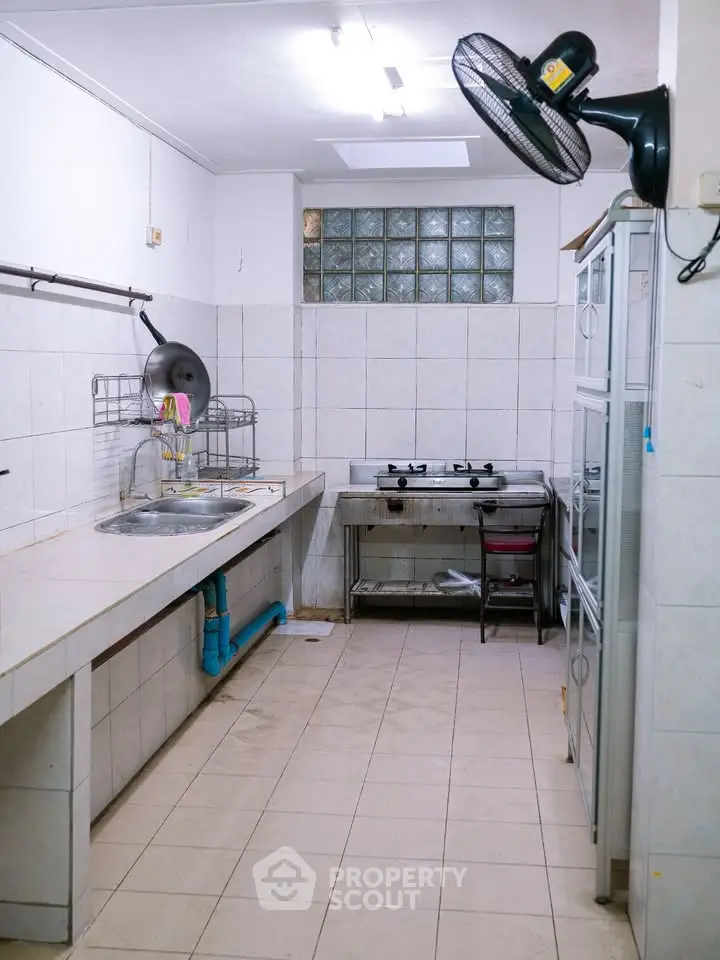 Spacious kitchen with gas stove and ample counter space in modern apartment