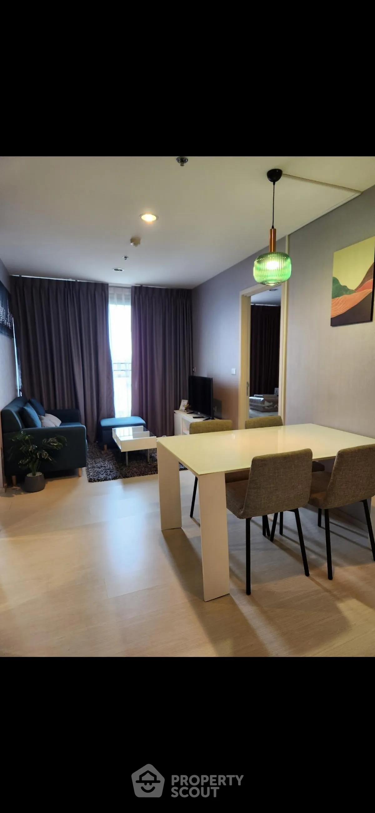 Modern living room with stylish decor and natural light, perfect for relaxation and entertainment.