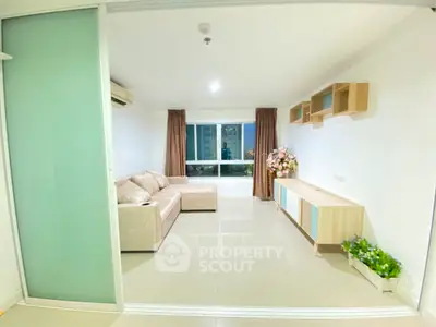 Spacious and well-lit living room with modern furnishings and large windows offering ample natural light, perfect for comfortable urban living.