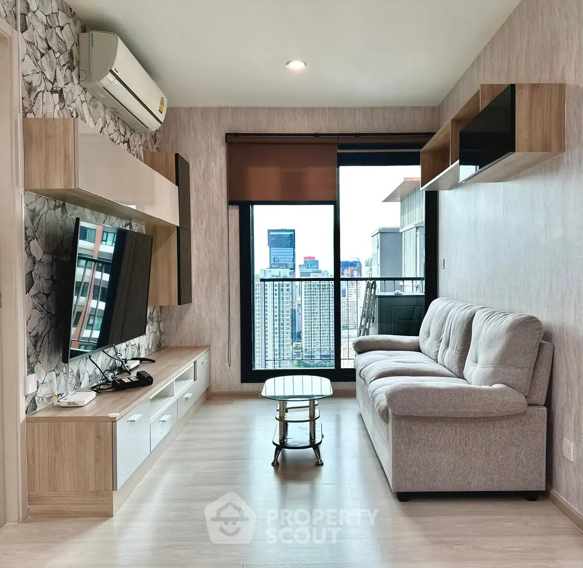 Modern living room with city view, stylish furniture, and natural light.