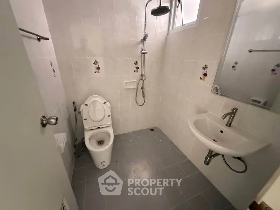Compact bathroom with modern fixtures and shower in a real estate property.