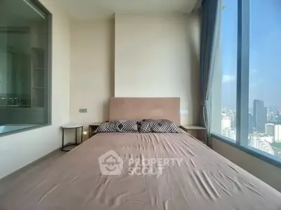 Modern bedroom with large window offering stunning city view