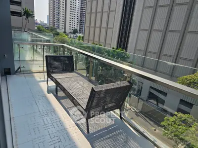 Spacious balcony with modern seating and city view, perfect for relaxation and enjoying urban living.