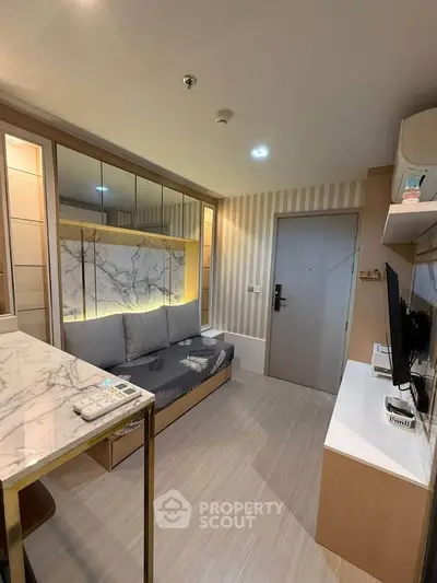 Modern living room with stylish decor and marble accents in a cozy apartment.