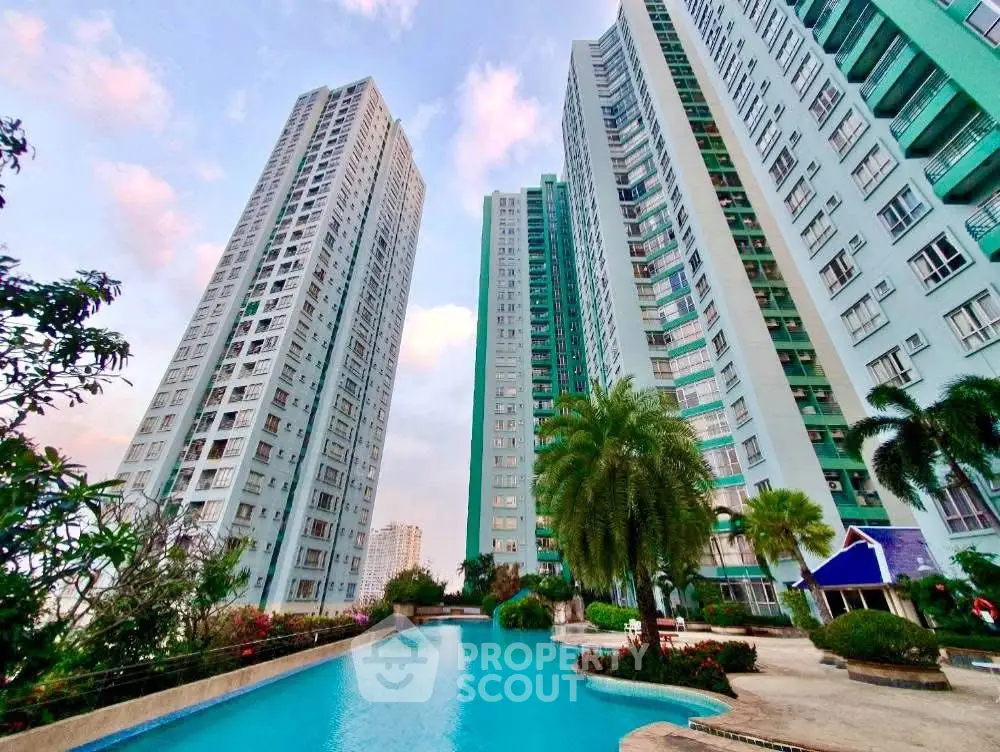 Stunning high-rise residential buildings with a luxurious pool and lush landscaping.
