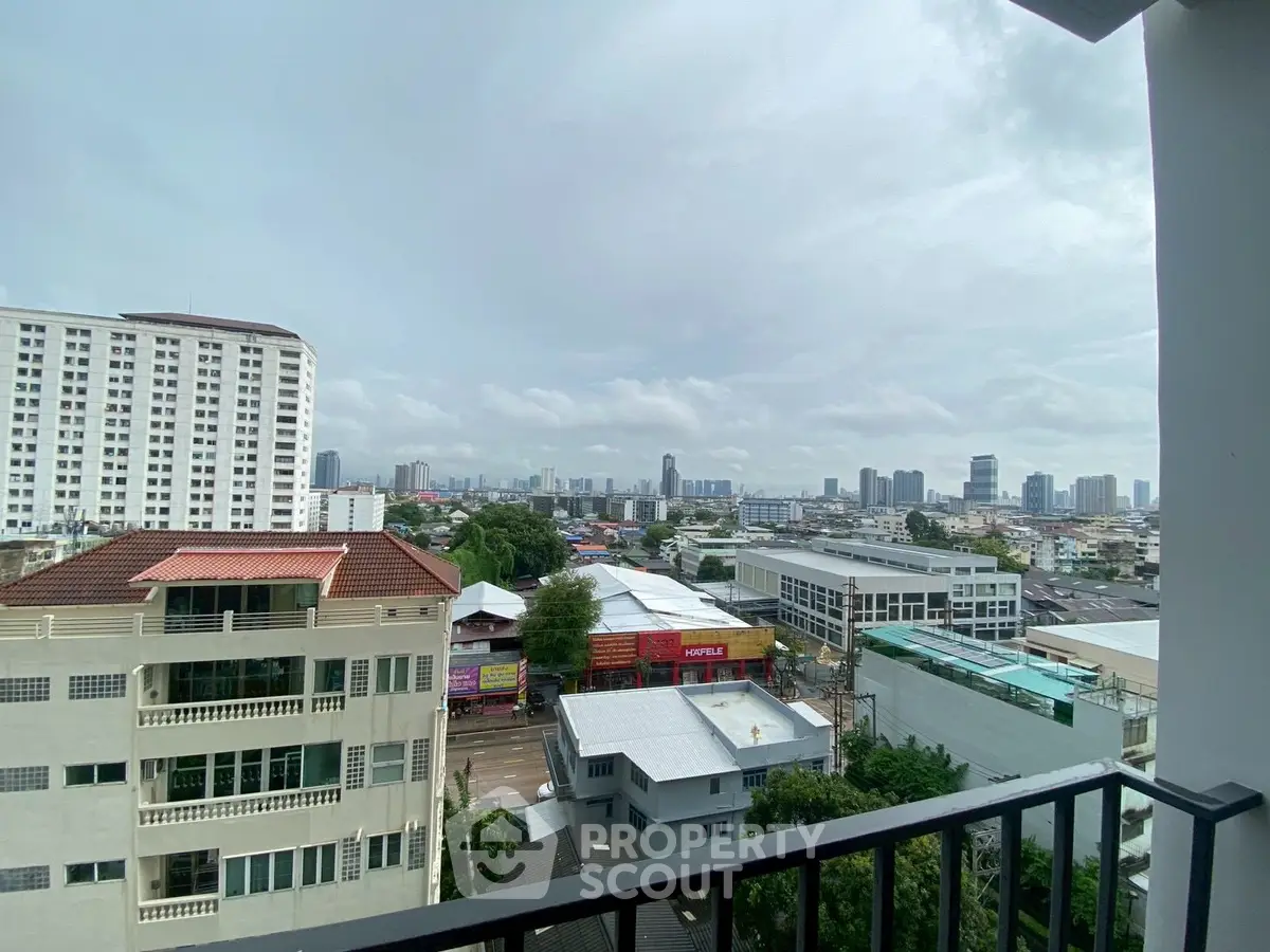 Stunning cityscape view from a high-rise balcony overlooking urban skyline.