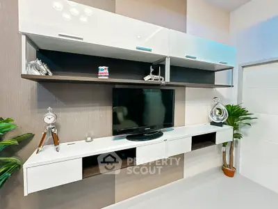 Modern living room with sleek wall-mounted entertainment unit and stylish decor.