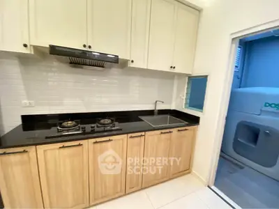 Modern kitchen with gas stove and sleek cabinetry in a compact layout